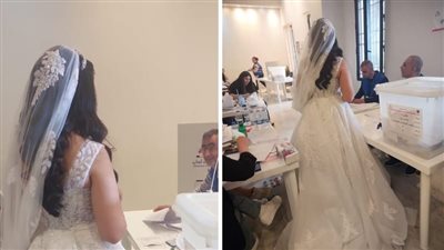 عروس في فستان الزفاف تدلي بصوتها في مركز اقتراع